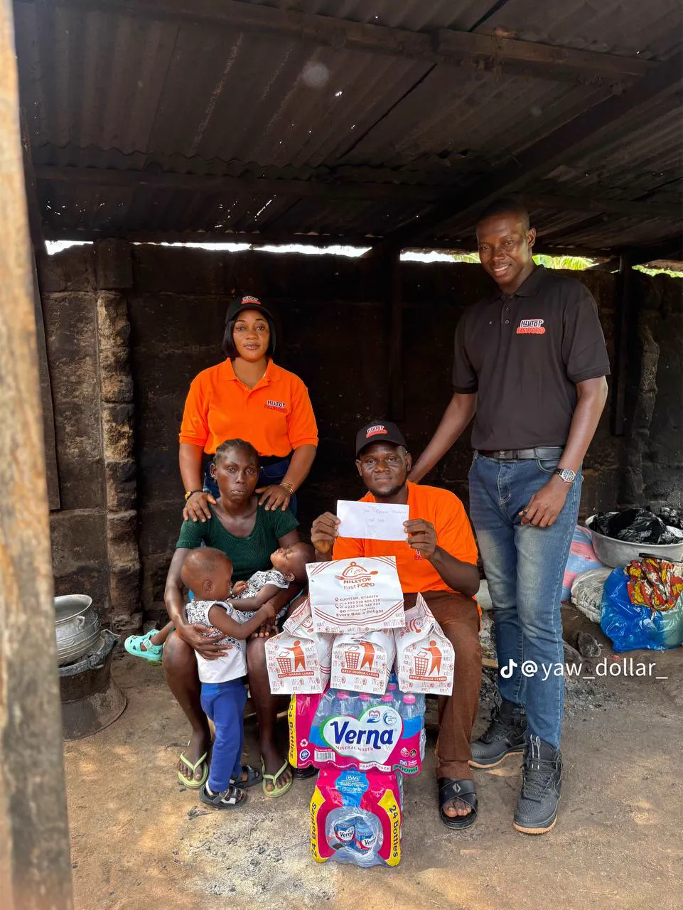 Oracle Foundation volunteers handing food packs to a family