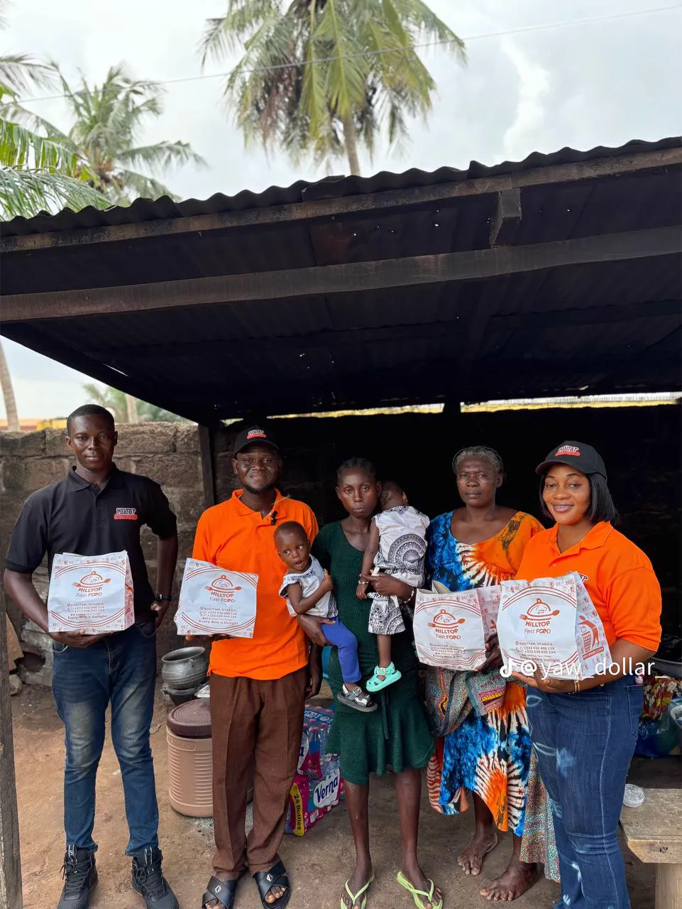 Volunteers and families standing together with food packs